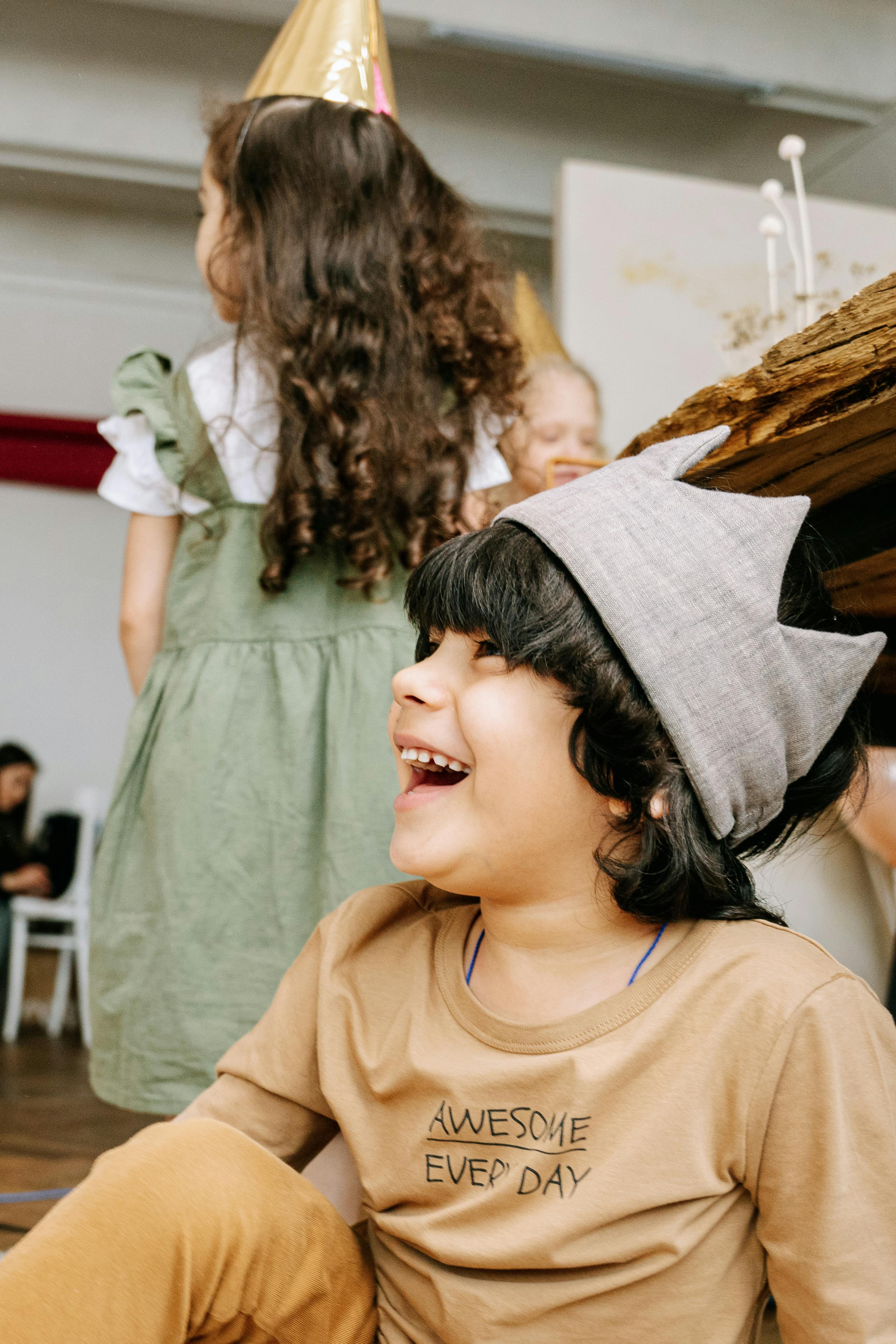A laughing child wearing a fabric crown